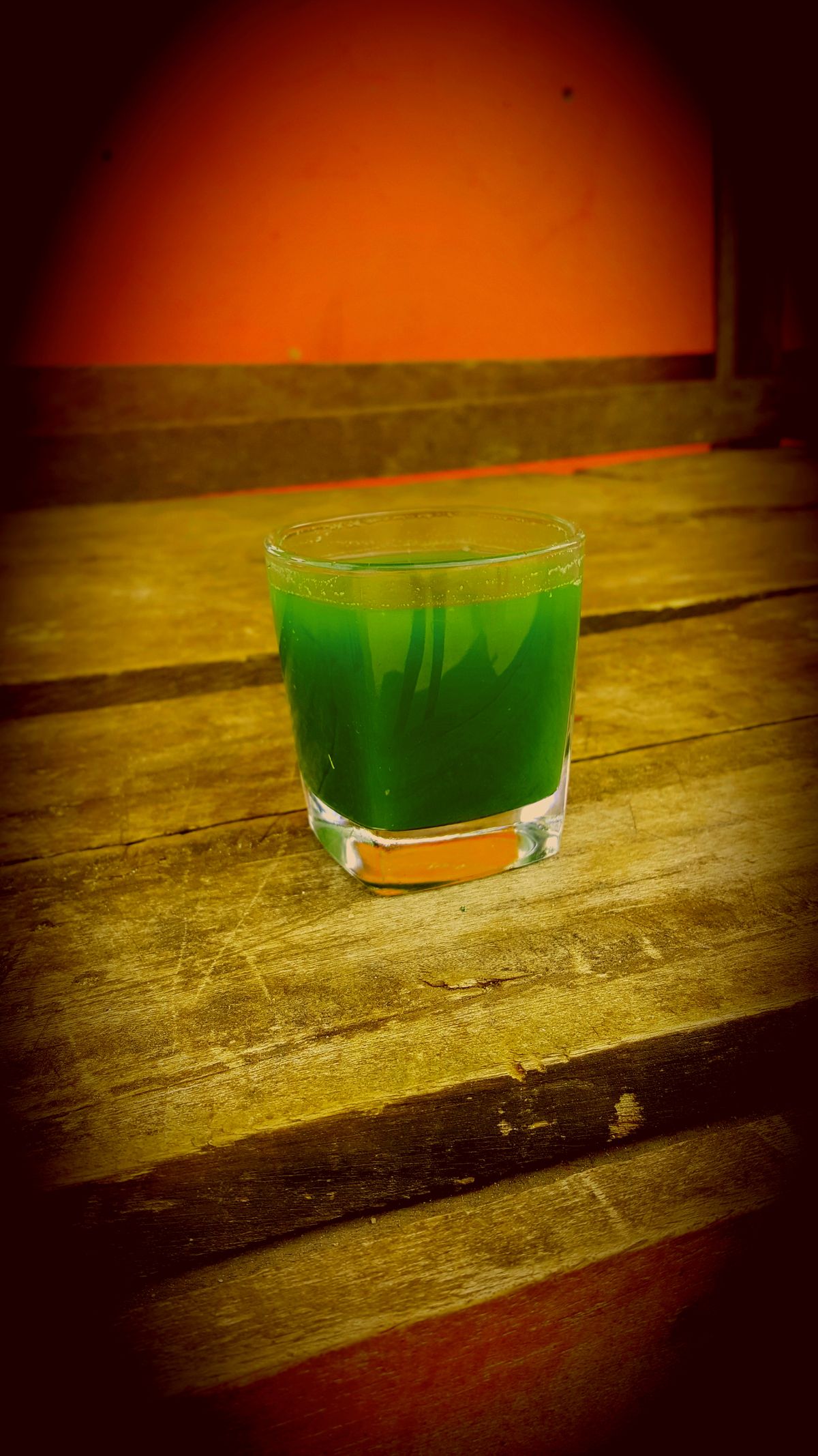 A glass of fresh wheatgrass juice